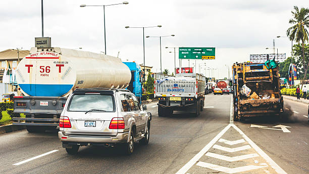 Lagos, Nigeria - June 4, 2014: Morning traffic in one of the biggest cities in Africa, trucks and other vehicles on the road.